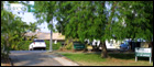 Entry signs around driveway into Ti Tree Apartments